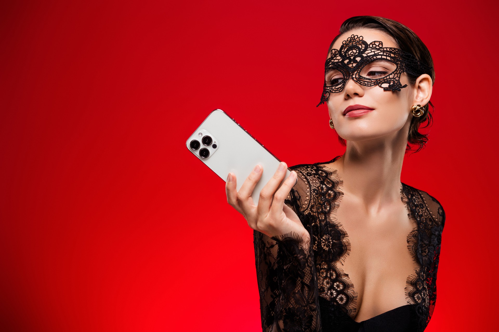 Photo of attractive sexy young girl old look gadget dressed lace black dress mask queen incognito red color background